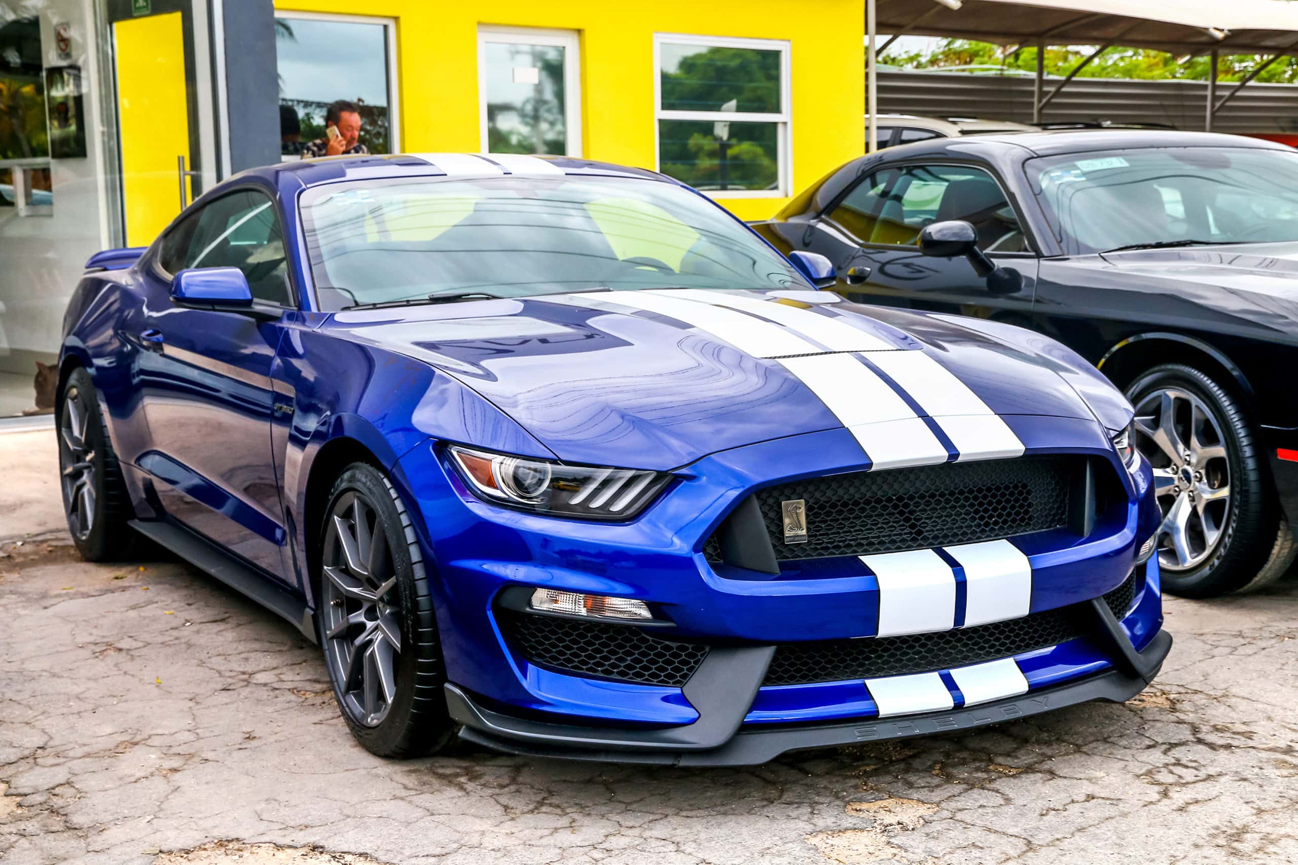 blue car with white hood stripes