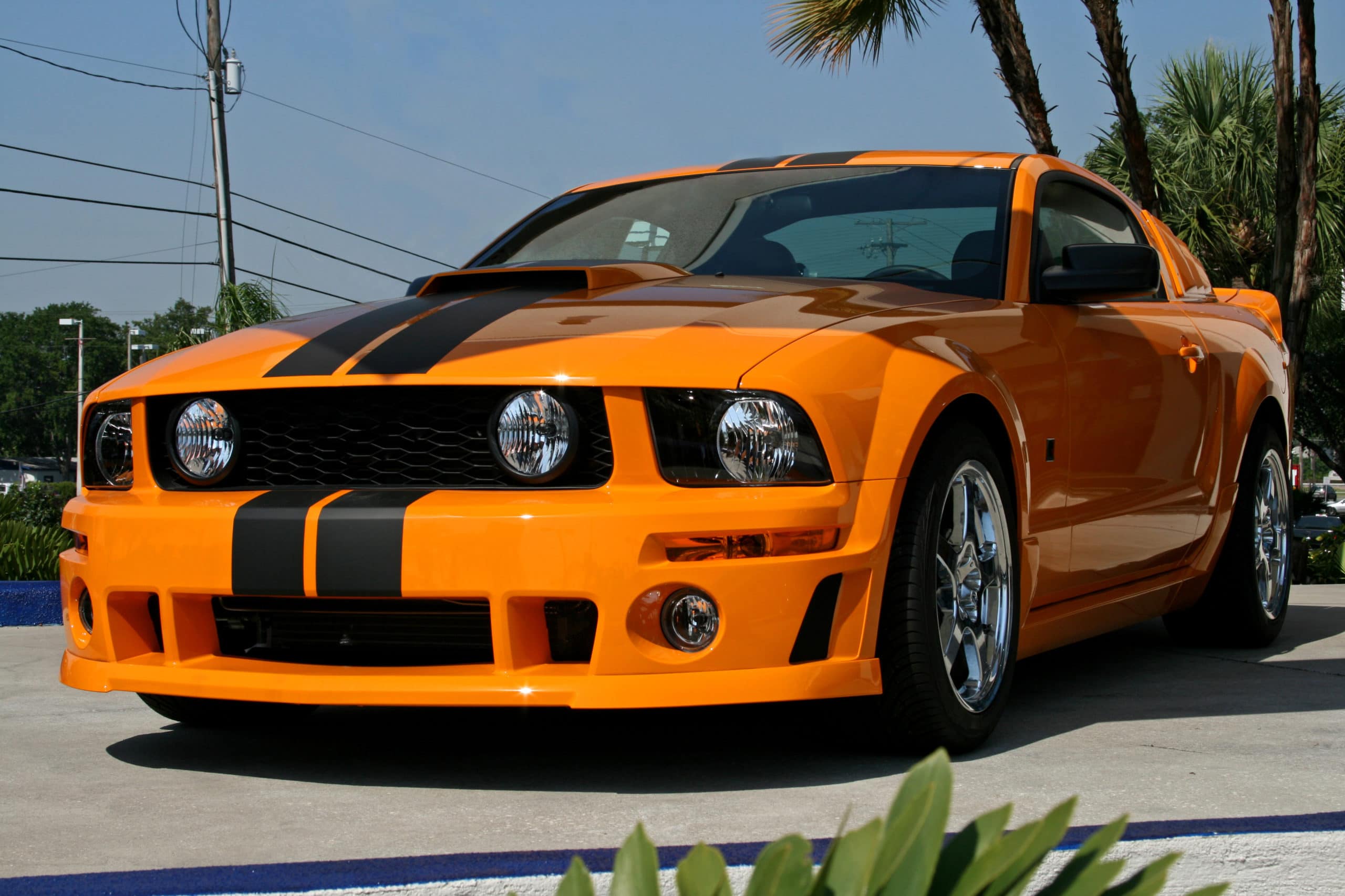 orange car with hood stripes