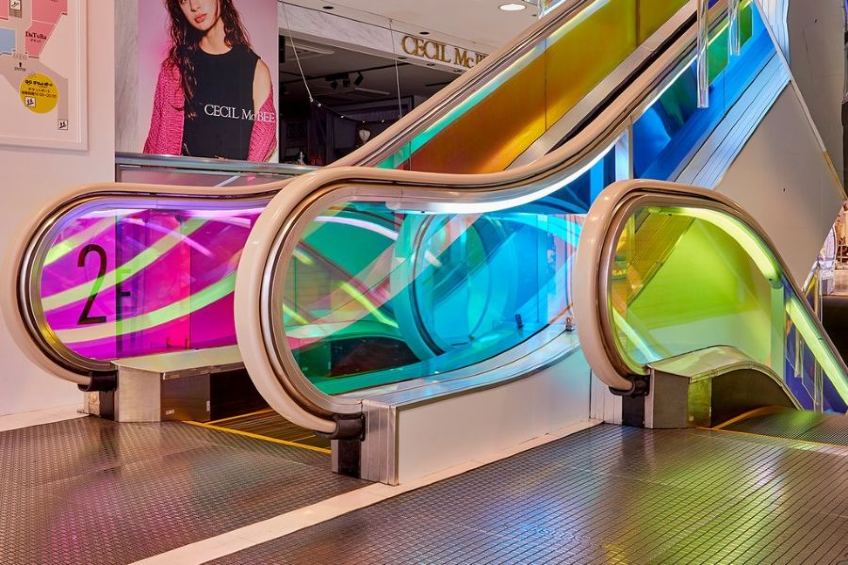 3M Dichroic Glass Finishes applied to an escalator.