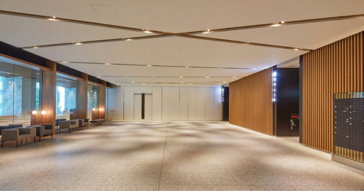 Modern commercial lobby featuring wood-finish architectural surfaces and contemporary interior design.