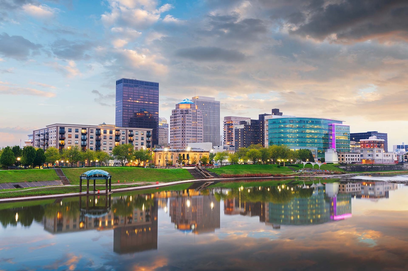 Dayton, Ohio downtown cityscape on the Miami River at dusk.