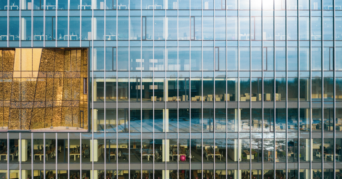 Reflective window film applied to a commercial building exterior, reducing glare and solar heat gain