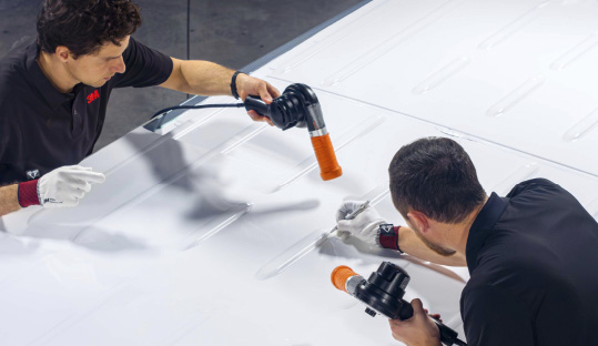 Two installers installing 3M Cooling Film